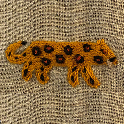 Embroidered leopard on linen serviette