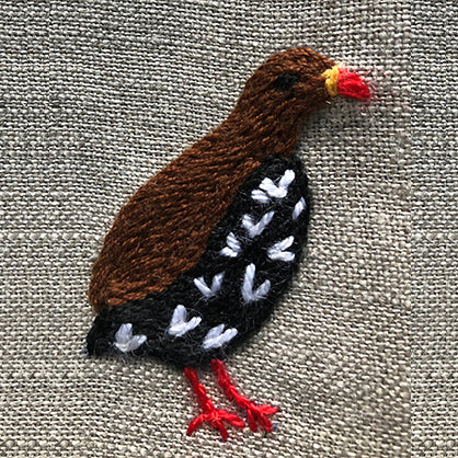 Indigenous South African bird hand embroidered on table napkin