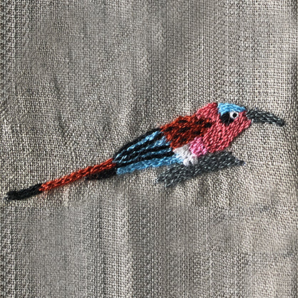 Lilac breasted roller embroidered on linen table napkin