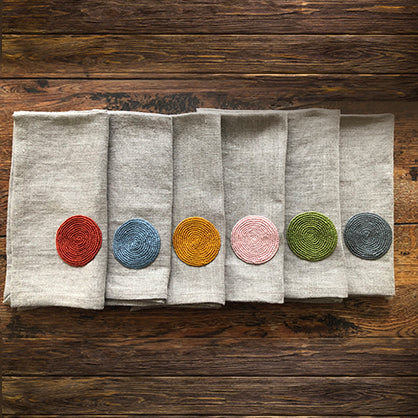 Autumn themed linen serviettes with embroidered circles in various colours