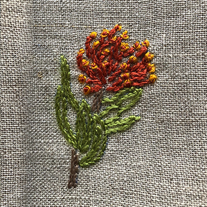 Hand-embroidered botanicals from Africa on a linen table napkin