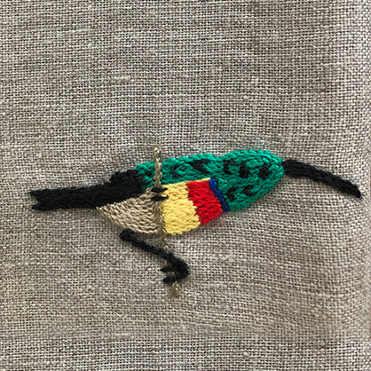 African bird hand embroidered on natural linen serviette