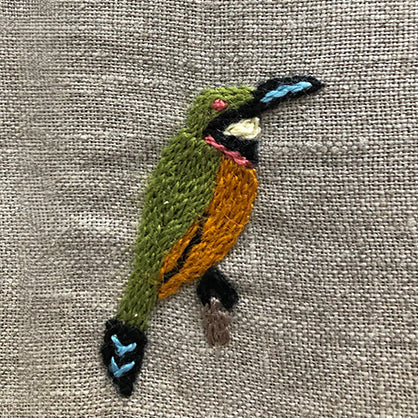 Green kingfisher embroidered on linen serviette