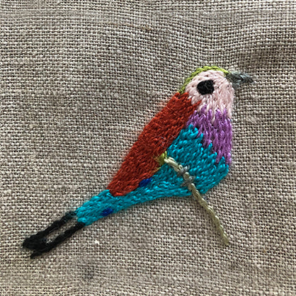 African bird embroidered on linen serviette