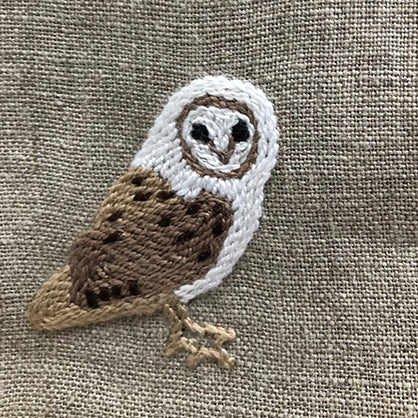 African grass owl embroidered on linen table napkin