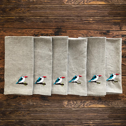 Set of six linen serviettes with woodland kingfishers embroidered on them
